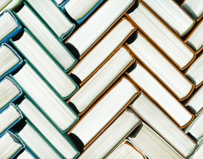 Stacks of books arranged in a herringbone order.