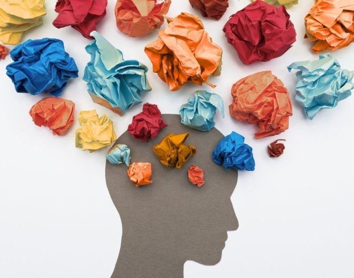 A head image with various coloured paper balls up above the head.