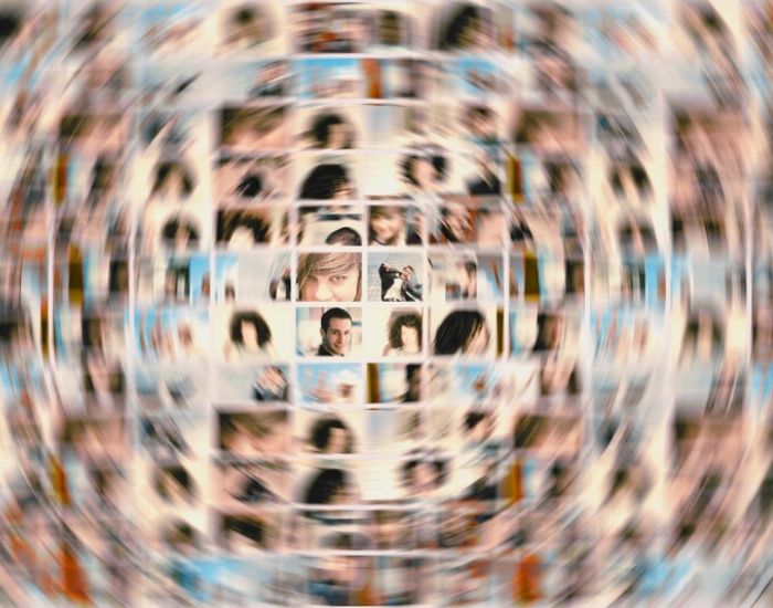 A montage of dozens of pictures of people's heads covered by a blurred circle.